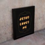 I Am a Child of God Bible wall art with bold gold text and a decorative gold border on a black background. Wall Art displayed on the wall in a black frame