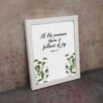 In His Presence There Is Fullness of Joy - Psalm 16:11 Bible Verse Wall Art with Green Leaf Design on White Background Wall Art displayed on the wall in a white frame