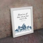 Psalm 2:12 Bible Verse Wall Art with deep blue mountain range design. Wall Art displayed on the wall in a white frame