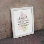 Psalm 18:3 Bible Wall Art with a soft pastel background and light green and beige leaves, featuring dark, elegant text. Wall Art displayed on the wall in a white frame