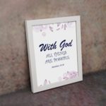 With God All Things Are Possible Matthew 19:26 Bible Verse Wall Art with purple text and light purple floral accents on a white background. Wall Art displayed on the wall in a white frame