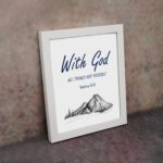 With God All Things Are Possible Matthew 19:26 Bible Verse Wall Art with dark blue text and mountain sketch on white background. Wall Art displayed on the wall in a white frame