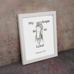 Infidu My Hope Is In You Lord Psalm 39:7 Bible Wall Art with a minimalist line drawing of figure in prayer and clean text Wall Art displayed on the wall in a white frame