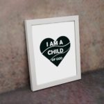 Infidu I Am A Child Of God Bible Wall Art with a dark green heart and white text on a white background Wall Art displayed on the wall in a white frame