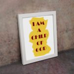 Infidu I Am A Child Of God Bible Wall Art with yellow shape and red text on a white background Wall Art displayed on the wall in a white frame