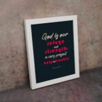 Infidu Psalm 46:1 Bible Wall Art with a deep blue background, pink and white text, featuring God is our refuge and strength. Wall Art displayed on the wall in a white frame