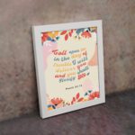 Psalm 50:15 Bible Verse Wall Art with colorful text, floral patterns, bird illustration, and beige background. Wall Art displayed on the wall in a white frame