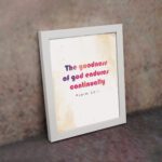 The Goodness Of God Endures Continually Psalm 52:1 Christian Wall Art with bold black and red text on a light cream background. Wall Art displayed on the wall in a white frame