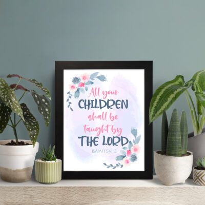 Christian wall art with Isaiah 54:13, featuring 'All Your Children Shall Be Taught By The Lord' in pastel watercolor with floral elements. Wall Art displayed on the table in a black frame