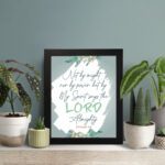 Infidu Zechariah 4:6 Christian wall art with decorative design and floral accents, featuring Not by Might, But by My Spirit. wall art displayed on the table in a black frame