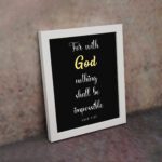 Luke 1:37 Bible verse wall art with black background, yellow highlights on God and Impossible. Christian home decor by Infidu. Wall Art on the wall in a white frame