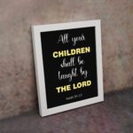 Infidu All Your Children Shall Be Taught By The Lord Isaiah 54:13 Bible Verse Wall Art with Purple Blue background, black leaf design, and white font white frame on the wall