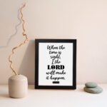 Infidu wall art displaying When the time is right, I, the LORD will make it happen in black text on a white background. displayed on the wall in a black frame