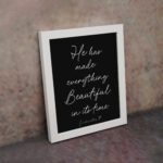 He Has Made Everything Beautiful Ecclesiastes 3:11 Christian Bible Verse Wall Art with White Text on Black Background. displayed on the wall in a white frame