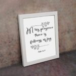 In His Presence There Is Fullness of Joy in a black script font with decorative branches and Psalm 16:11 on a white background - Christian wall art. displayed on the wall in a white frame