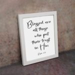 Blessed Are All Those Who Put Their Trust In Him Psalm 2:12 black cursive text on white background - Christian wall art displayed on the wall in a white frame