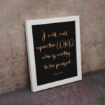 Psalm 18:3 wall art with gold text I will call upon the Lord on a black background in a black frame. Christian home decor. displayed on the wall in a white frame