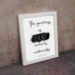 Infidu The Goodness Of God Endures Continually Psalm 52:1 Bible Wall Art with black text and brushstroke design on white background. Wall Art displayed on the wall in a white frame