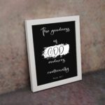 Infidu The Goodness of God Endures Continually Psalm 52:1 Bible Verse Wall Art with white text on black background. Wall Art displayed on the wall in a white frame