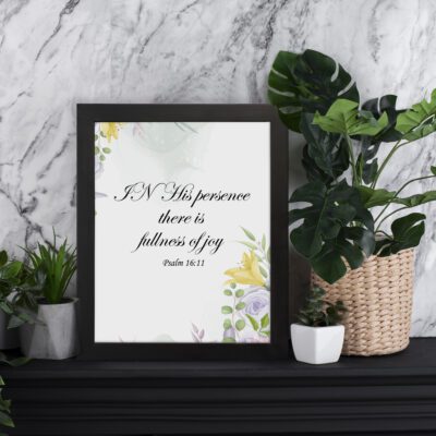 In His Presence There Is Fullness of Joy - Psalm 16:11 Bible Verse Wall Art with Pastel Floral Design on White Background Wall Art displayed on the wall in a black frame