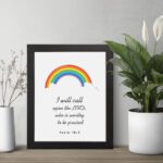 I Will Call Upon The Lord Psalm 18:3 Bible Wall Art with a colorful rainbow at the top and black text on a white background. Wall Art displayed on the wall in a black frame