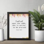 I Will Call Upon The Lord Psalm 18:3 Bible Verse Wall Art with handwritten text and colorful floral elements on a white background. Wall Art displayed on the table in a black frame