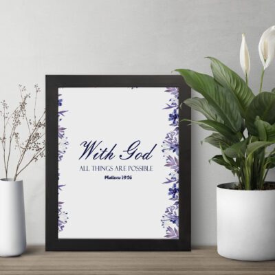 With God All Things Are Possible Matthew 19:26 Bible Verse Wall Art with blue text and watercolor-style floral border on a white background. Wall Art displayed on the table in a black frame