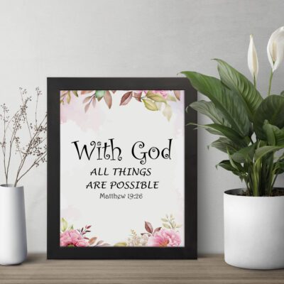 With God All Things Are Possible Matthew 19:26 Bible Verse Wall Art with black text and floral accents in pink and green on a white background. Wall Art displayed on the table in a black frame