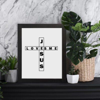 Infidu Jesus Loves Me Bible Wall Art with the crossword-style layout in black text on a white background Wall Art displayed on the table in black frame