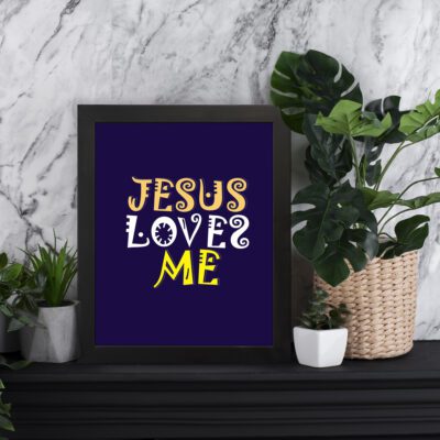 Infidu Jesus Loves Me Bible Wall Art with deep purple background and yellow decorative lettering Wall Art displayed on the table in a black frame