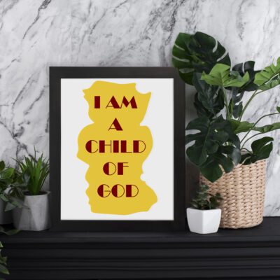 Infidu I Am A Child Of God Bible Wall Art with yellow shape and red text on a white background Wall Art displayed on the table in a black frame