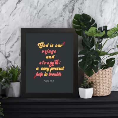 Psalm 46:1 Bible Wall Art with bold, colorful text on a deep black background. Wall Art displayed on the table in a black frame