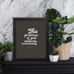 The Goodness of God Endures Continually Psalm 52:1 Christian wall art with white text on a dark gray background. Wall Art displayed on the table in black frame