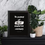 Infidu The Goodness Of God Endures Continually Psalm 52:1 Christian wall art with bold white text on a black background. Wall Art displayed on the table in a black frame