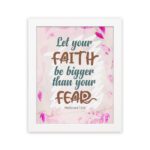 Christian wall art with brown 'Faith' and 'Fear' text, pink leaves, and a light pink floral background. Wall Art hung on the wall in a white frame