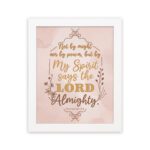 Zechariah 4:6 Christian wall art featuring Not By Might Nor By Power in gold script on a light peach background with floral accents. Wall Art hung on the wall in a white frame