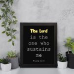 Psalm 54:4 Bible Verse Wall Art - The Lord Is The One Who Sustains Me in bold text on a black background for Christian home decor. Wall Art displayed on the wall in a black frame