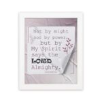 Zechariah 4:6 Bible verse wall art with soft purple text, bold LORD, decorative plant motif, and light purple folded paper background. hung on the wall in a white frame