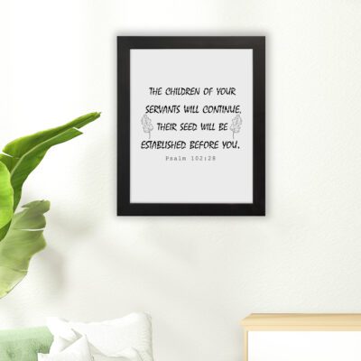 Bible verse wall art with Psalm 102:28 in black text on a white background, featuring decorative leaf designs for an elegant touch. hung on the floor in a black frame