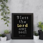 Infidu Bless The Lord O My Soul Psalm 103:1 Bible Wall Art with Black Background and Yellow, White Font black frame displayed on the wall