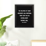 Bible verse wall art with Psalm 102:28 in bold white text on a black background. Centered and simple design for easy readability. hung on the floor in a black frame