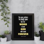 Infidu The Grass Withers The Flower Fades But The Word Of Our God Will Stand Forever Isaiah 40:8 Bible Wall Art and black frame hung on the wall