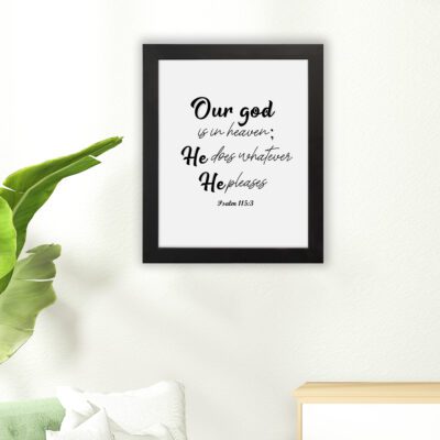 Bible verse wall art with Psalm 115:3 in black text on a white background. Modern design with cursive and standard fonts. hung on the floor in a black frame