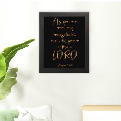 Joshua 24:15 Bible wall art with golden text on a black background, emphasizing LORD in a decorative font. hung on the floor in a black frame