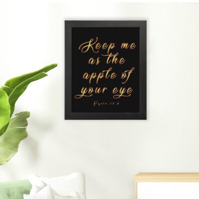 Keep Me As The Apple Of Your Eye Psalm 17:8 gold cursive text on black background - Christian wall art for home decor hung on the floor in a black frame