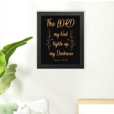 The Lord My God Lights Up My Darkness Psalm 18:28 gold text on black background Christian wall art hung on the floor in a black frame