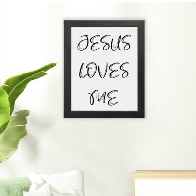 Jesus Loves Me Bible wall art with black script text on a white background. Wall Art hung on the floor in a black frame