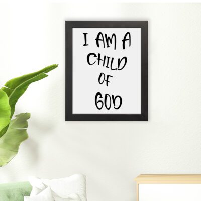 I Am a Child of God Bible wall art with bold black text on a white background, framed by a subtle black border. Wall Art hung on the floor in a black frame