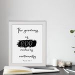 Infidu The Goodness Of God Endures Continually Psalm 52:1 Bible Wall Art with black text and brushstroke design on white background. Wall Art displayed on the table in a white frame