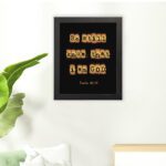 Be Still and Know That I Am God - Psalm 46:10 Bible Verse Wall Art with Scrabble-like Letters on Dark Background Wall Art displayed on the wall in a black frame